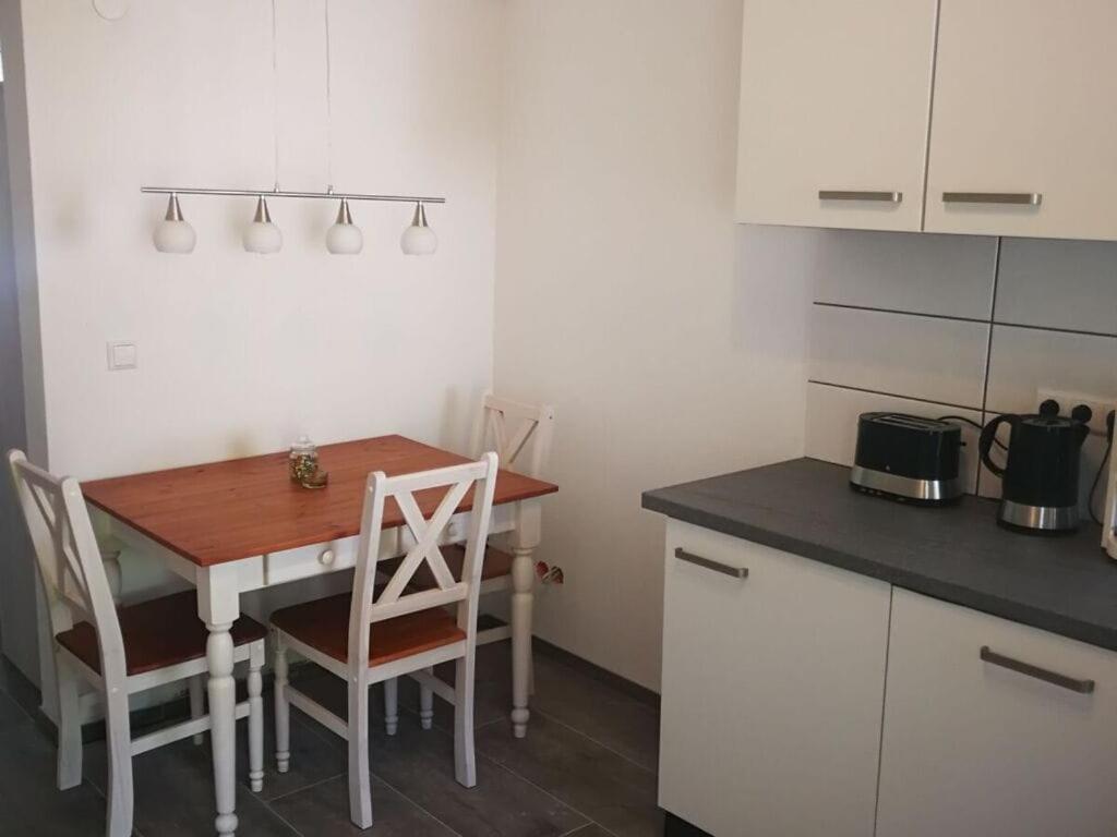 a kitchen with a table and chairs in a room at Pleasant apartment in Baden-Württemberg in Eisenbach