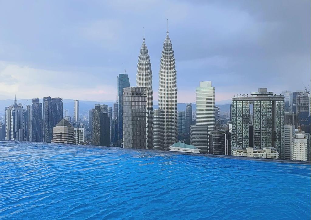 a view of the kuala lumpur city skyline from a swimming pool at The Platinum 2 Kuala Lumpur By Collective Haus in Kuala Lumpur