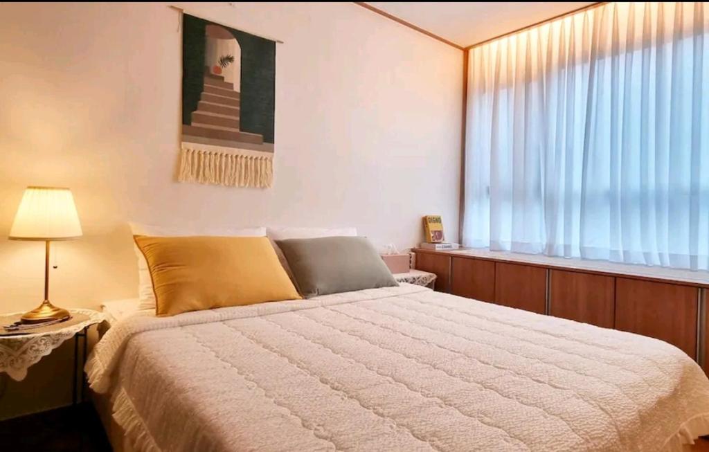 Postel nebo postele na pokoji v ubytování NK House