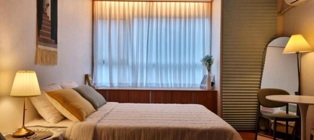 Postel nebo postele na pokoji v ubytování NK House