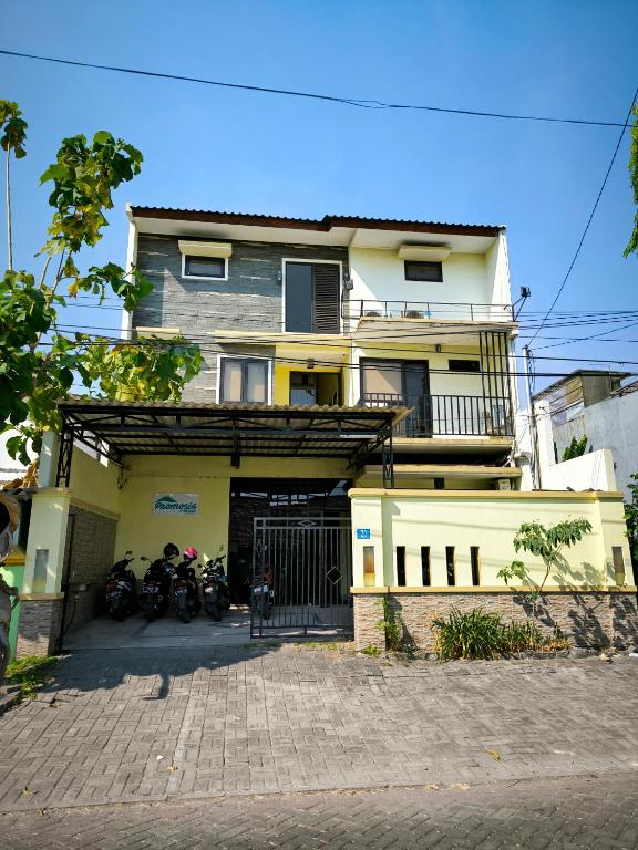 a house with motorcycles parked in front of it at PROMOSIA GUEST HOUSE in Surabaya