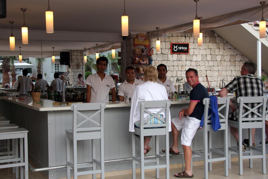 a group of people standing at a bar at Oludeniz Blue Lagoon Beach Hotel in Fethiye