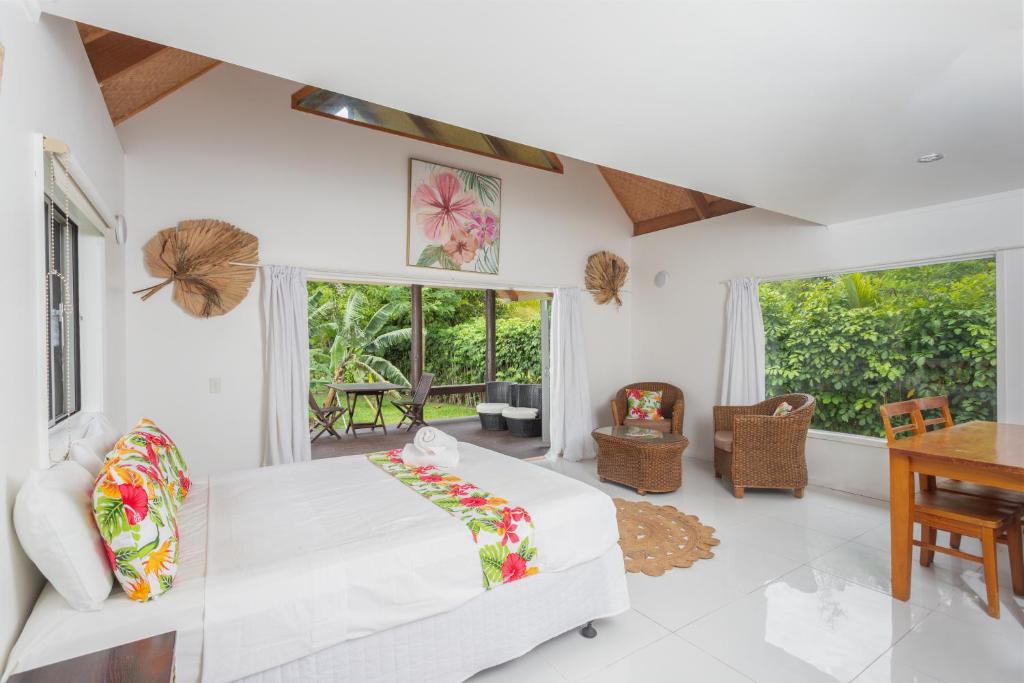 a living room with a white couch and a table at Bella Beach Lodge in Rarotonga