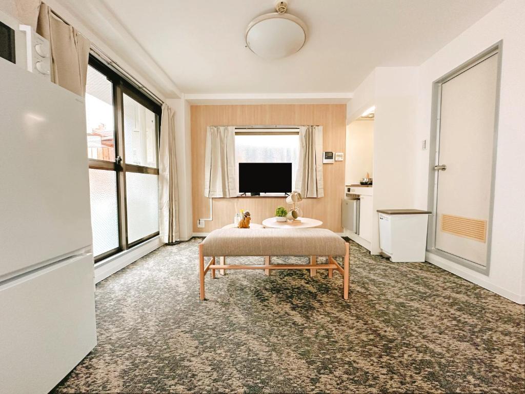 a living room with a table and a tv at 龙猫民宿-梅田店303 in Osaka