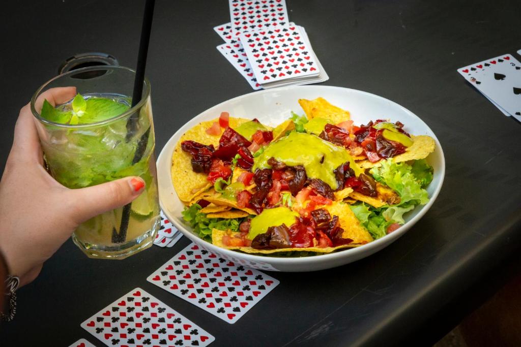 a salad in a bowl on a table with a drink at Plus Florence in Florence