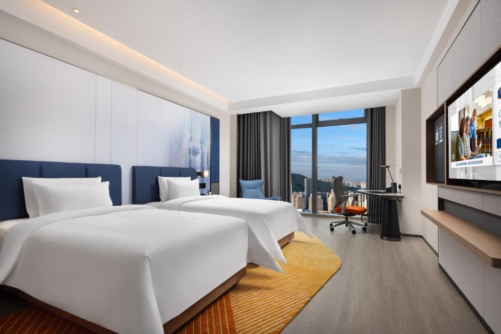 Postel nebo postele na pokoji v ubytování Hampton by Hilton Shenzhen Futian Huaqiangbei