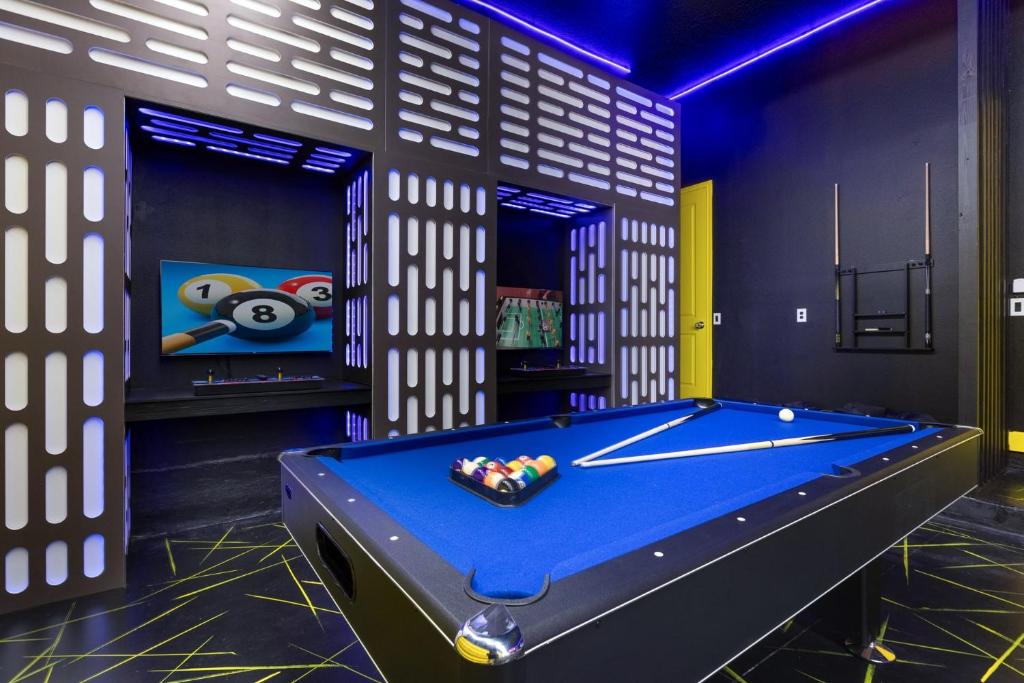 a billiard room with a blue pool table at Home Next to Seaworld w Pool, Hot Tub, Theatre, Games in Orlando