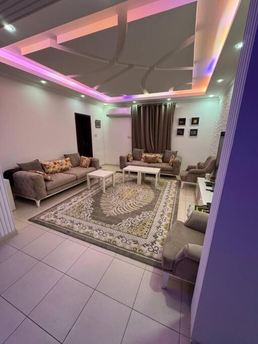 a living room with couches and a rug at City center 1 bedroom apartment in Muscat