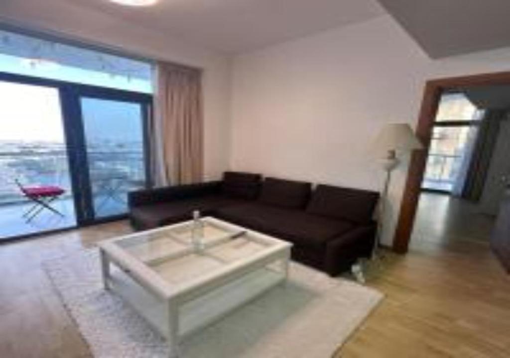 a living room with a couch and a coffee table at Key View - Binghatti Apartments in Dubai