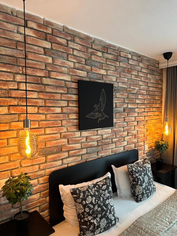 a brick wall with a couch in a living room at Hotel Art in Varna City