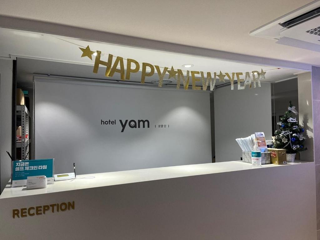 a happy anniversary sign above a counter in a store at Hotel Yam in Busan