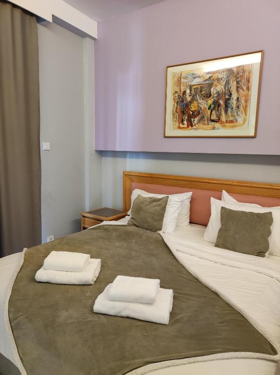 Postel nebo postele na pokoji v ubytování N E P center Hotel Rodos