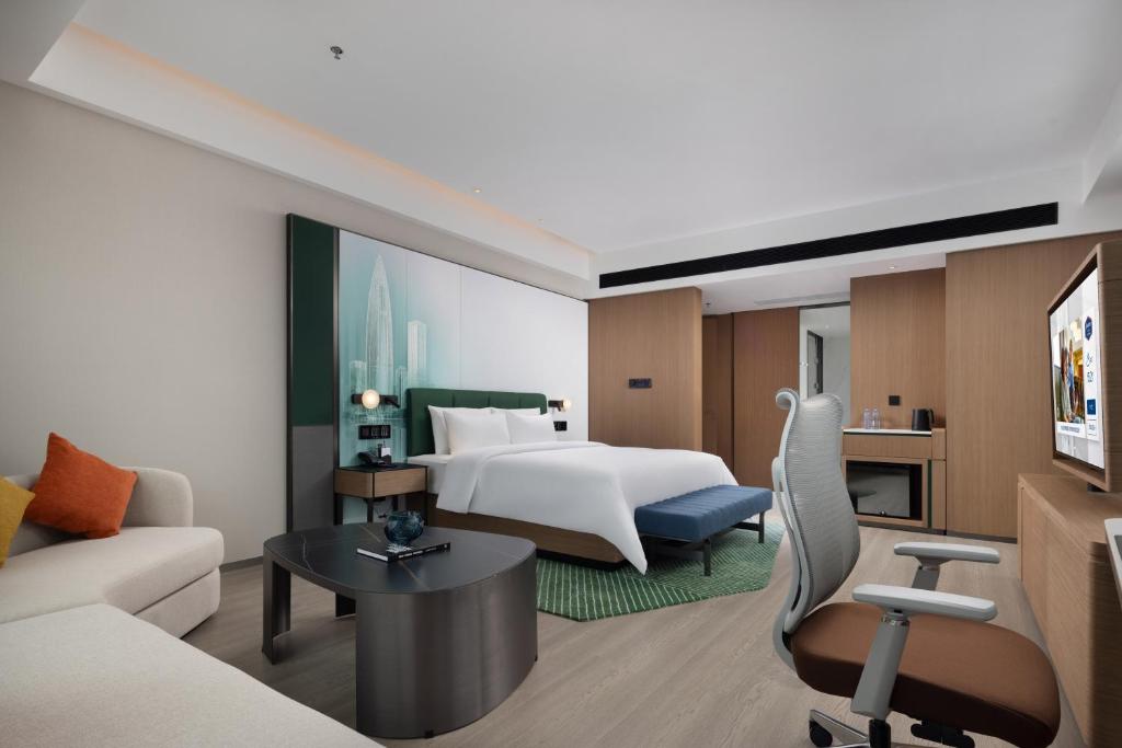 Postel nebo postele na pokoji v ubytování Hampton by Hilton Shenzhen Futian Huaqiangbei