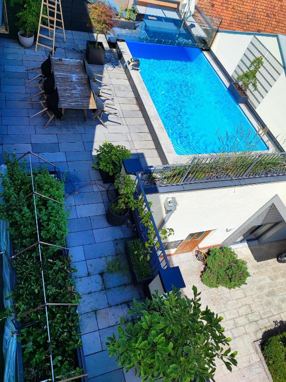 an overhead view of a swimming pool with benches and plants at LUXUS sApartments in der Kunstvilla &amp; kostenloses parken in Premstätten