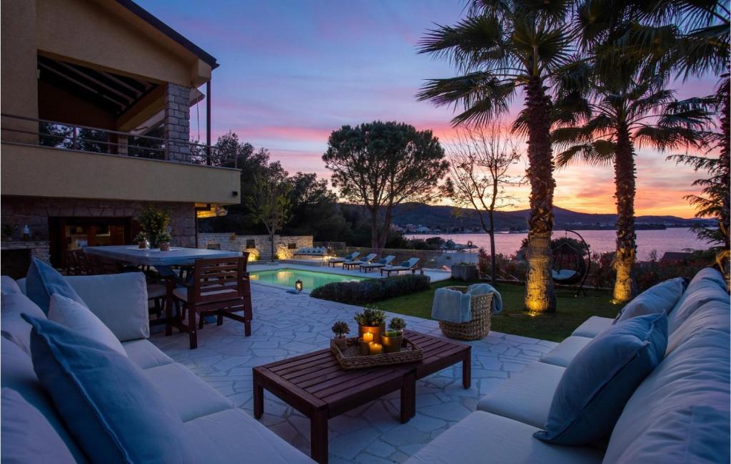 a patio with a couch and a table and a pool at Villa Barotul with pool in Mrljane