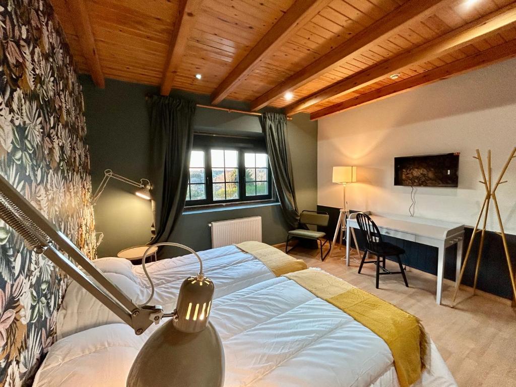 a bedroom with a bed and a desk in a room at Casa Bolboreta in Palas de Rei