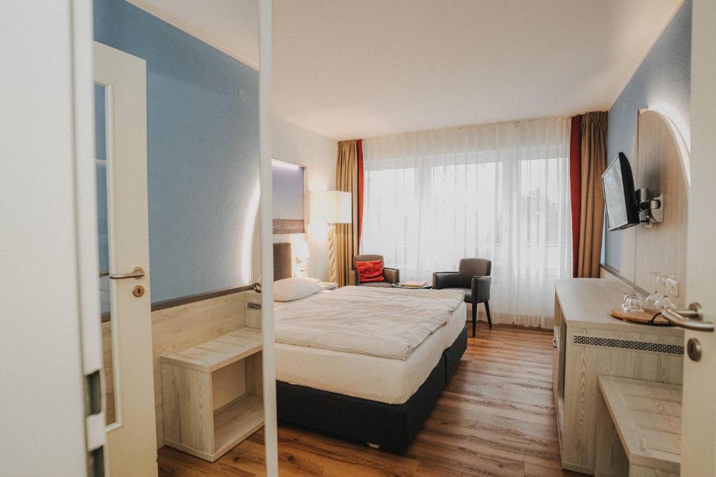 Postel nebo postele na pokoji v ubytování Hotel Spiekeroog