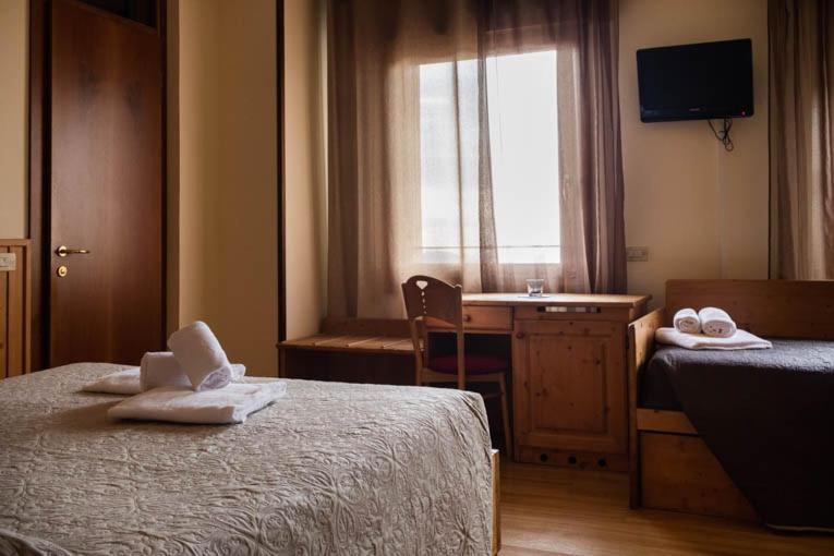 Postel nebo postele na pokoji v ubytování Locanda Montegrappa