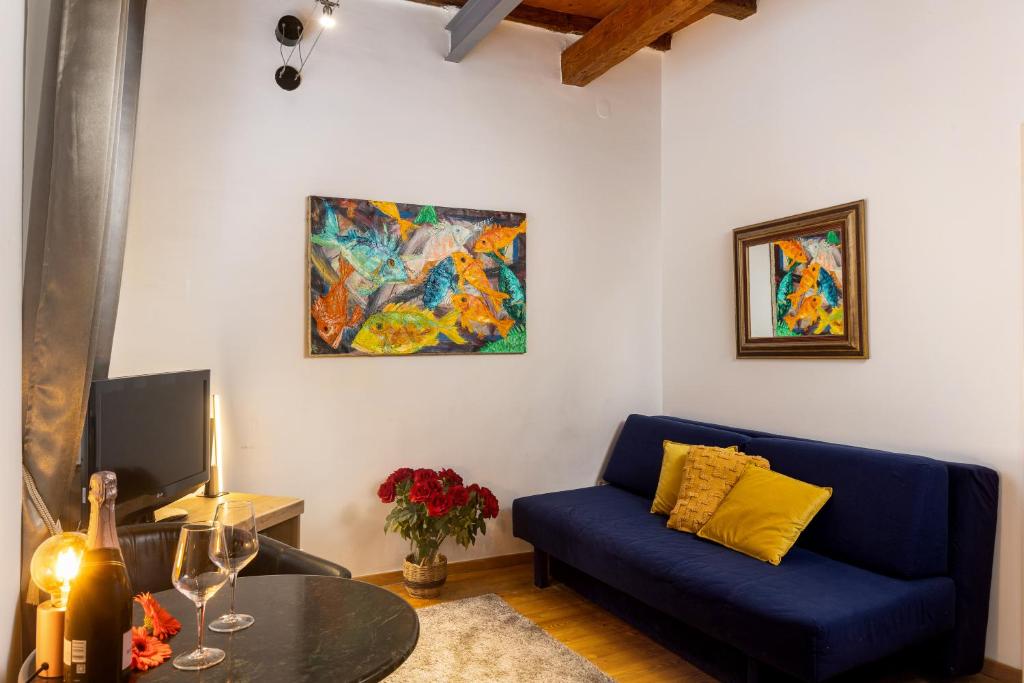 a living room with a blue couch and a painting at Hidden Gem Old Town in Dubrovnik
