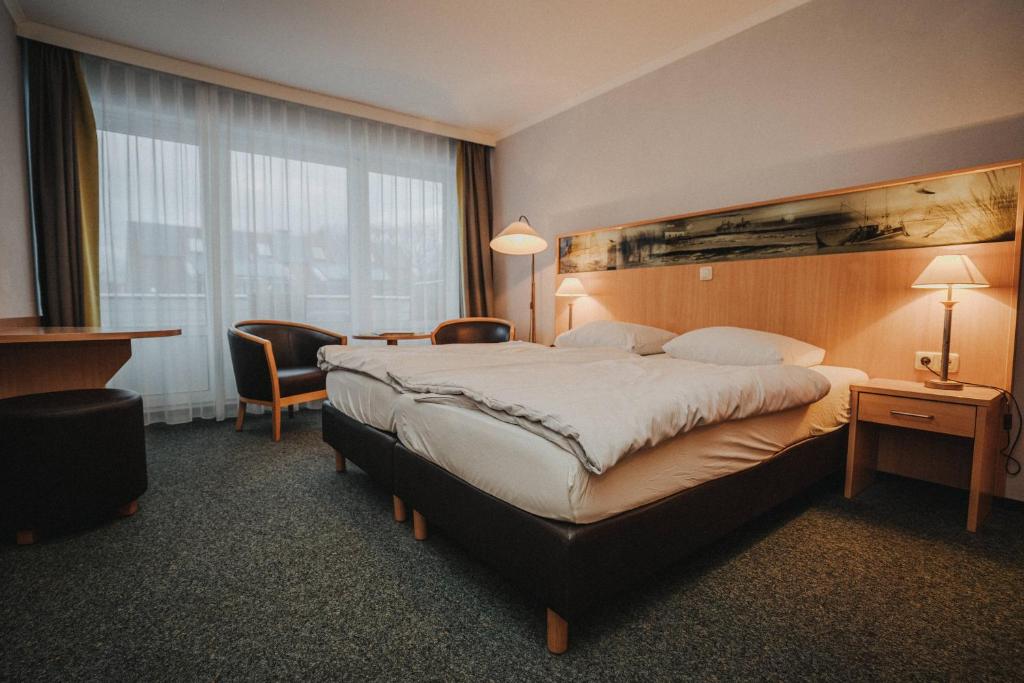Postel nebo postele na pokoji v ubytování Hotel Spiekeroog