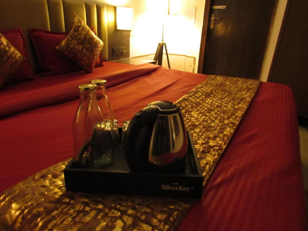 a tray with two bottles of wine on a bed at Peaceful Stay in New Delhi