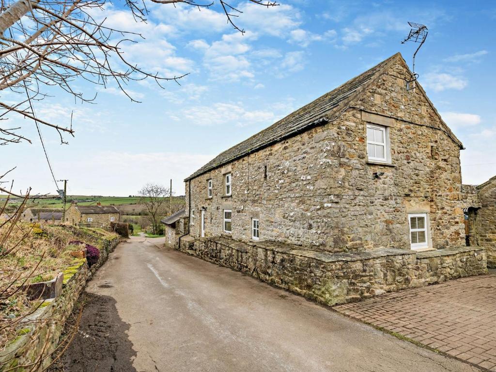 an old stone house on the side of a road at 3 Bed in Wolsingham 94198 in Wolsingham