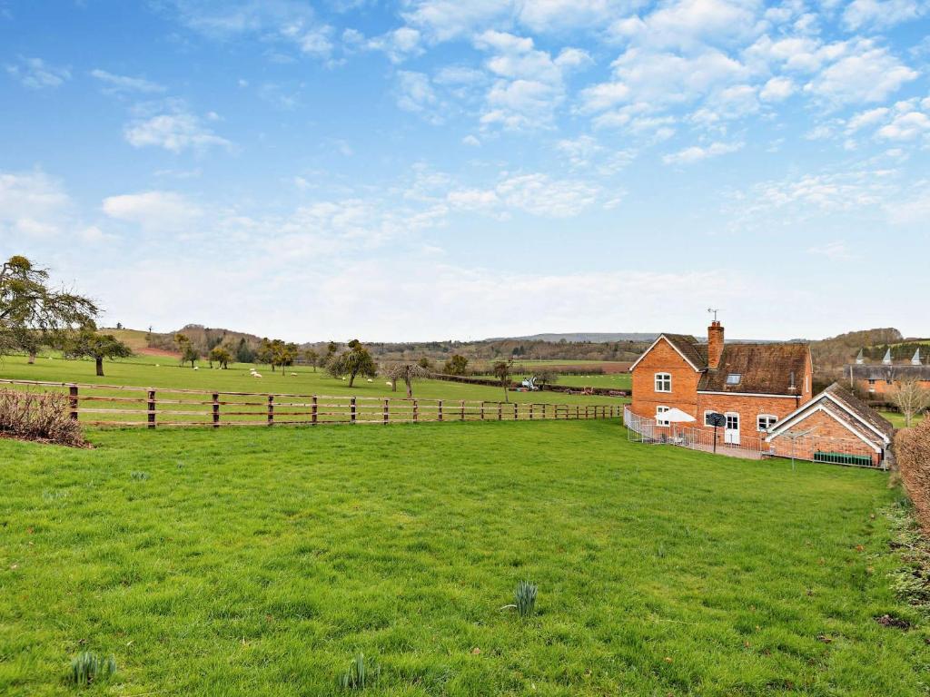 a large field with a house and a fence at 3 Bed in Lower Rochford 94240 in Newnham