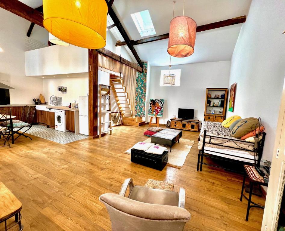 a large living room with wooden floors and a kitchen at ApartHotel Riviera - V Maison Bonaparte -Vieux Port Place du Pin in Nice