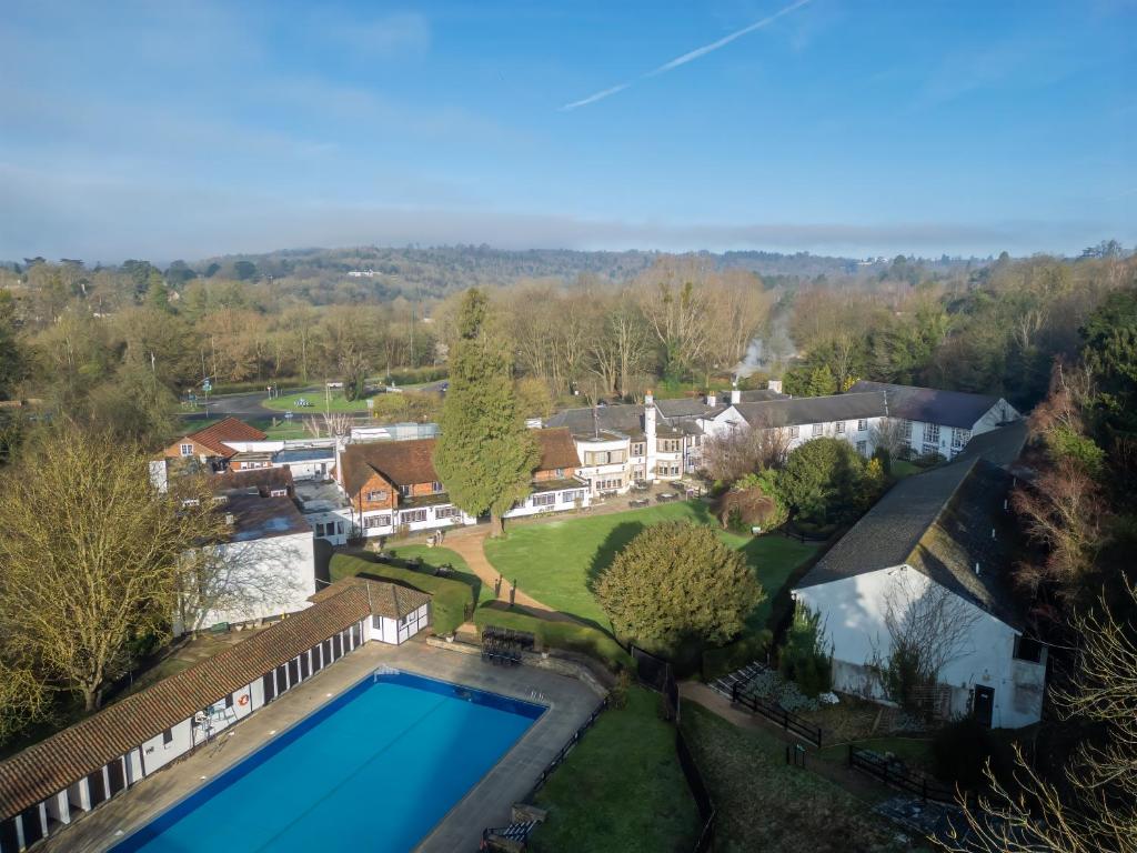 an aerial view of a house with a swimming pool at Mercure Box Hill Burford Bridge Hotel in Dorking