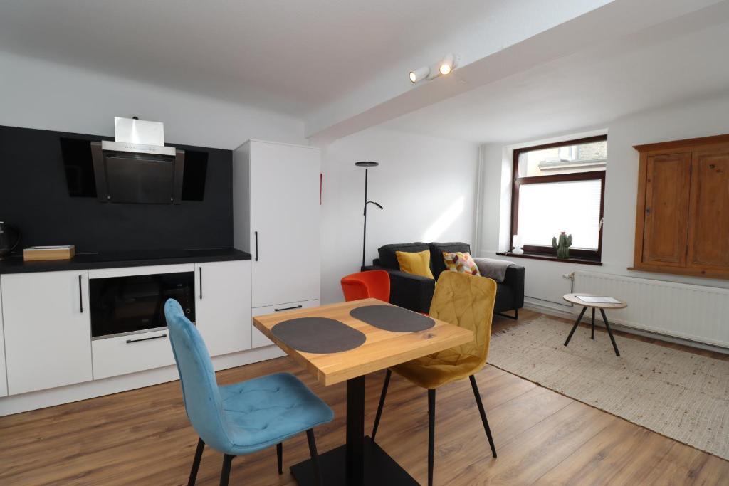 a living room with a table and a couch at Louisappart - Eupen Zentrum in Eupen