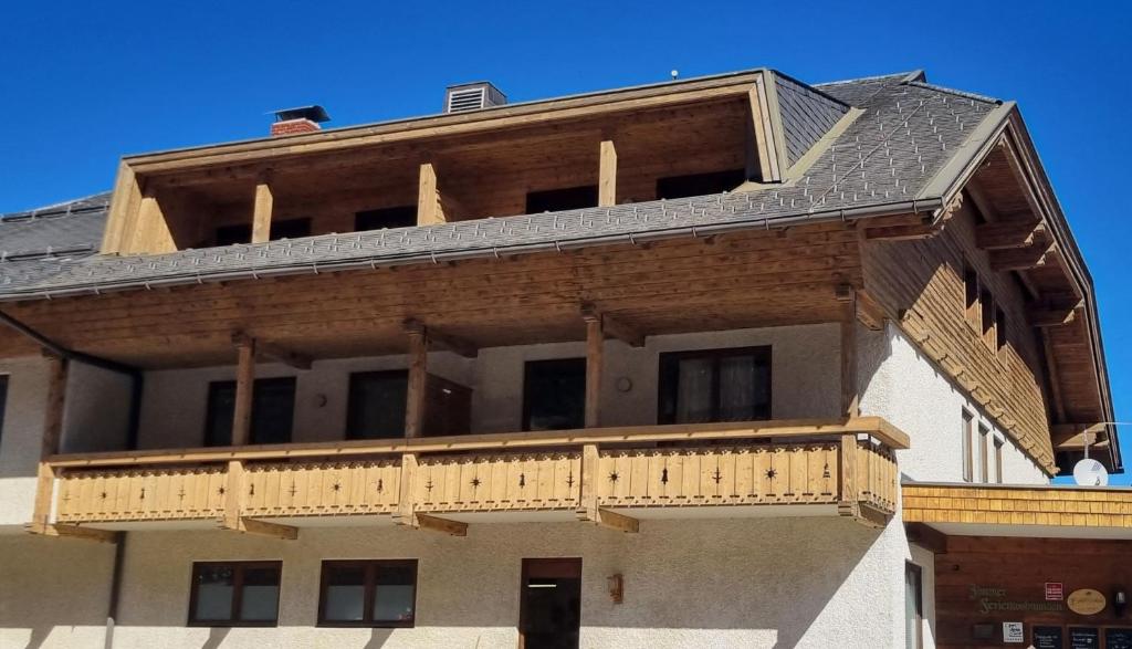 a building with a balcony on top of it at Hotel Baumgartnerhof in Altfinkenstein