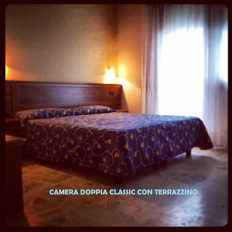 Postel nebo postele na pokoji v ubytování Hotel Miramare Chioggia Sottomarina