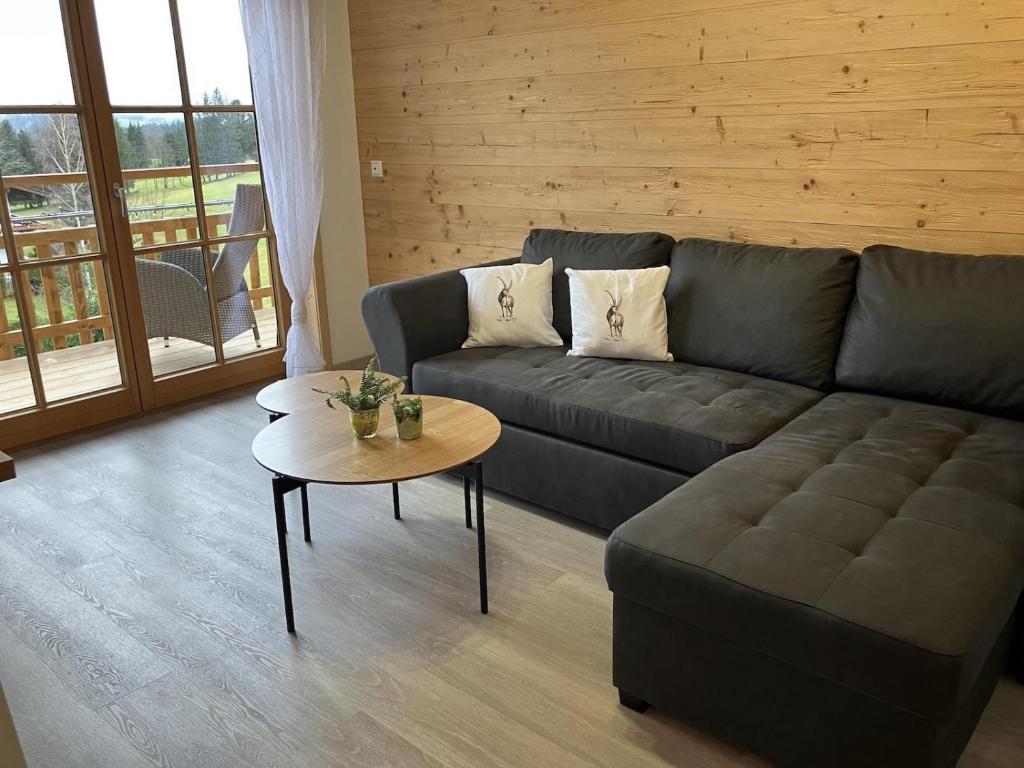 a living room with a couch and a table at Bergbauernhof Wechs in Ofterschwang
