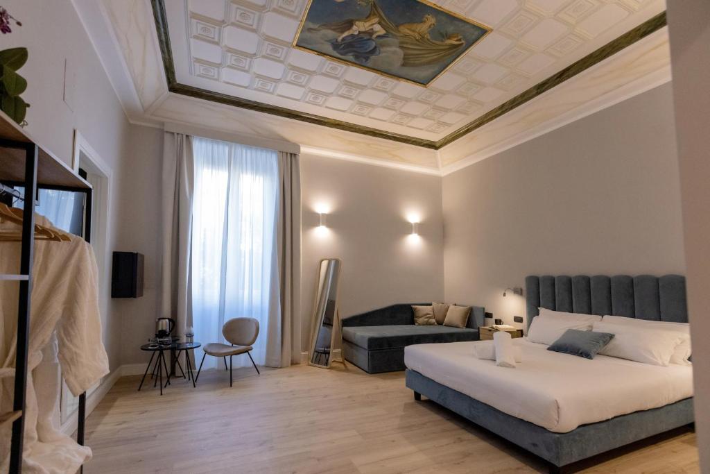 a bedroom with a bed and a couch at Relais At Via Veneto in Rome