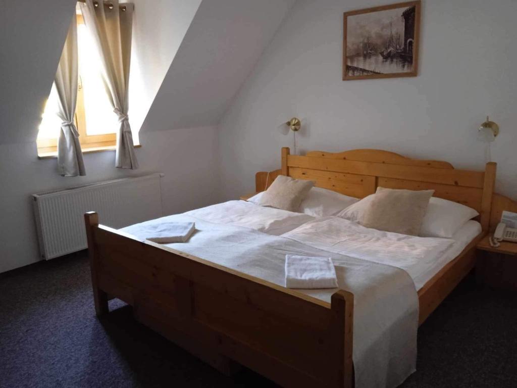A bed or beds in a room at Hotel Koliba
