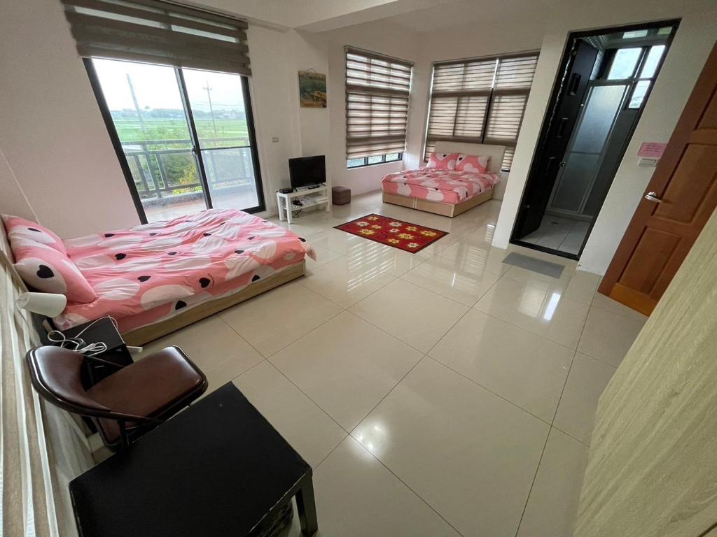 a large room with two beds and a television at Soul Home in Jiaoxi