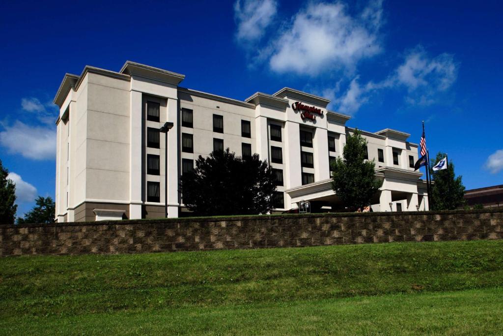 a white building with a fence in front of it at Hampton Inn Easton in Easton