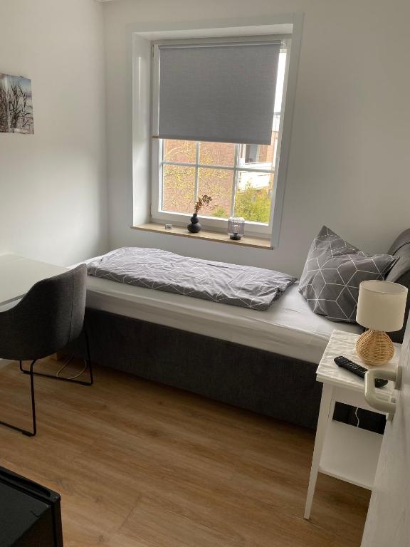 a bed sitting under a window in a room at Haus Bielefeld Zimmer 30a in Norderney