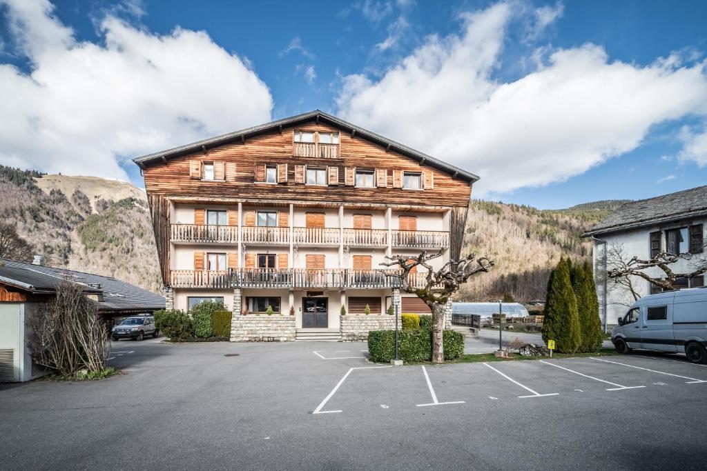 a large wooden building in a parking lot at Au soleil des coeurs - 6 pers in Morzine