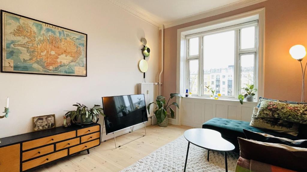 een woonkamer met een bank en een tv bij ApartmentInCopenhagen Apartment 1593 in Kopenhagen