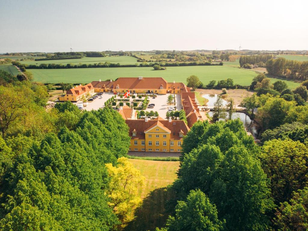 an aerial view of a house in the middle of trees at Broløkke Herregård in Humble