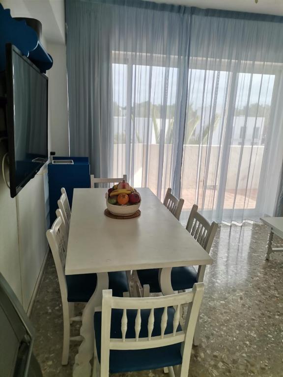 a dining room table with a bowl of fruit on it at apartamento Mirada I 22 ET-294PL in Es Pujols