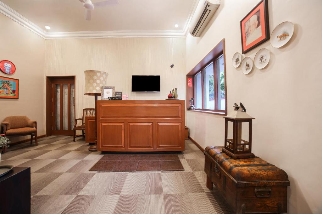a living room with a wooden cabinet and a tv at Super Townhouse 1267 Dayal Lodge - A Boutique Hotel in Agra