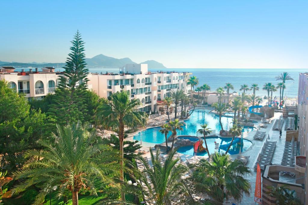 an aerial view of a resort with a swimming pool at Grupotel Alcudia Pins in Playa de Muro