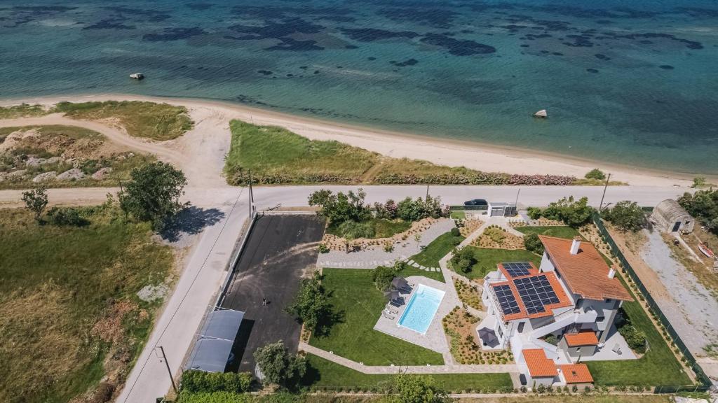 an aerial view of a house next to the beach at Electra BeachFront Suites, Nea Irakleia in Nea Iraklia
