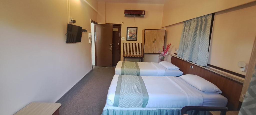 Postel nebo postele na pokoji v ubytování Hotel Swaroop