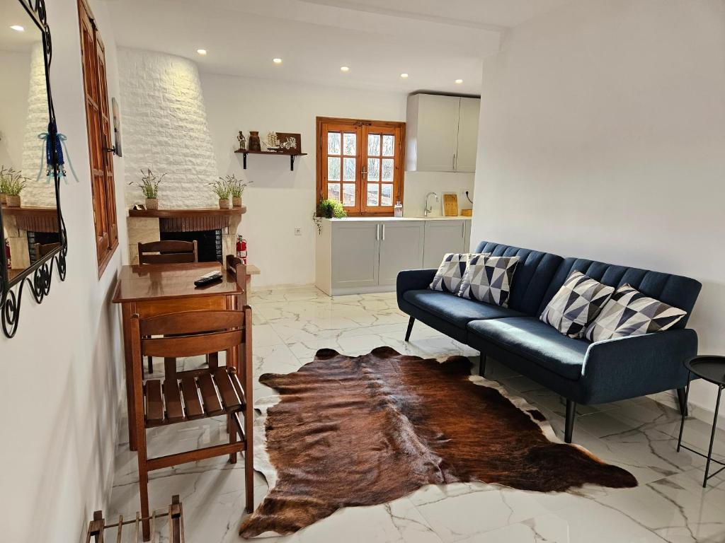 a living room with a couch and a table at Sandy Coast Apartments in Nea Kalikratia