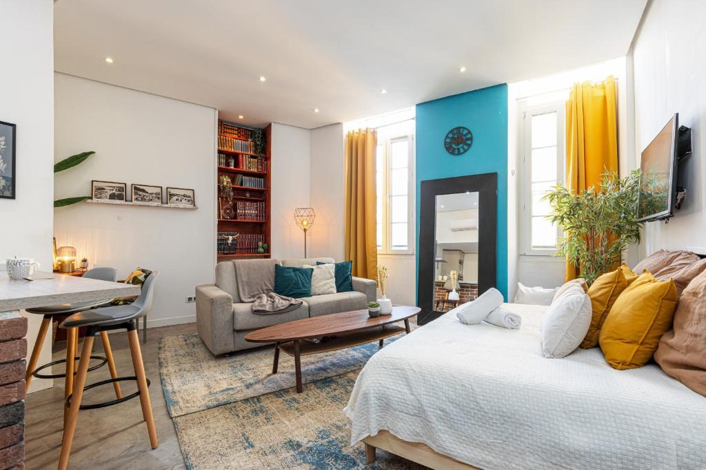 a living room with a bed and a dining room at Cosy Studio in the Old Town near Garibaldi Square in Nice