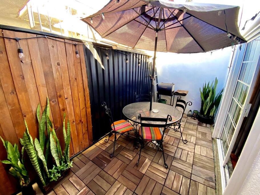 a patio with a table and an umbrella at Jaguar Studio in Tijuana