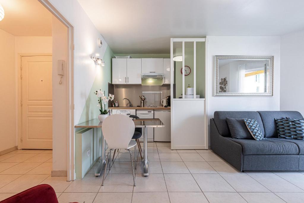 a living room with a couch and a kitchen at Quiet 1 bdr Port! close Place du Pin Garibaldi in Nice